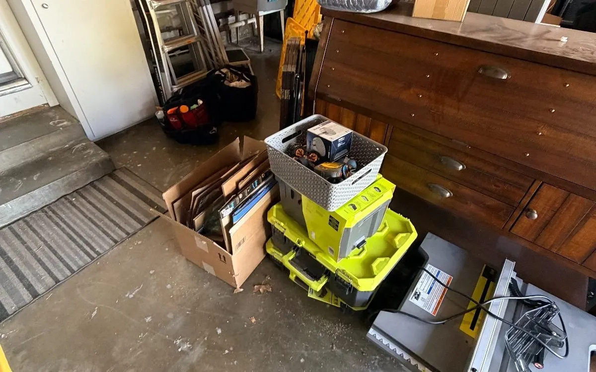 Garage crowded with furniture, boxes and tools before a cleanout