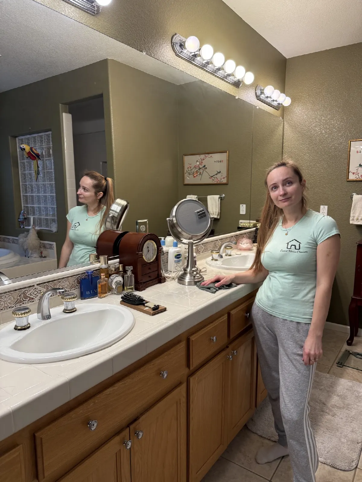 Crew member wiping down the bathroom vanity during an Airbnb turnover clean