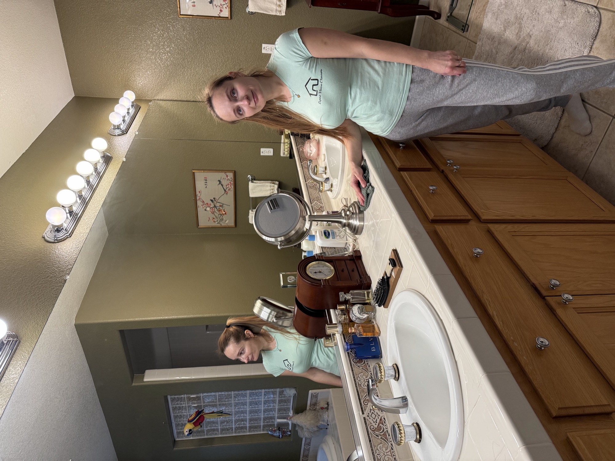 Crew member wiping down the bathroom vanity during an Airbnb turnover clean